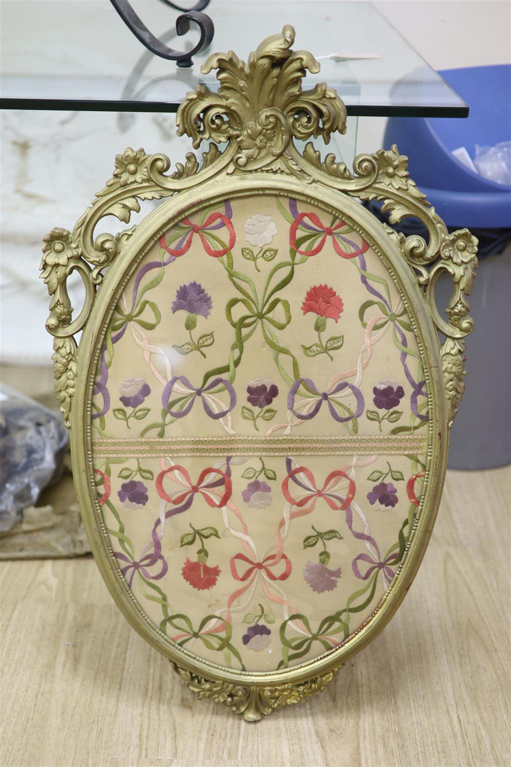 An oval needlework panel and another, largest 39 x 59cm